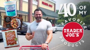 A man stands outside Trader Joe's with a shopping cart, holding a snack. Text reads "40 of my favorite Trader Joe's products for nutrition," with images of cottage cheese, chicken, and lentils.