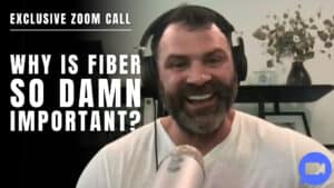 A man wearing headphones and holding a microphone smiles during a Zoom call, with text beside him reading, "Why is fiber so damn important?"—perfect for personal trainers discussing nutrition with clients.